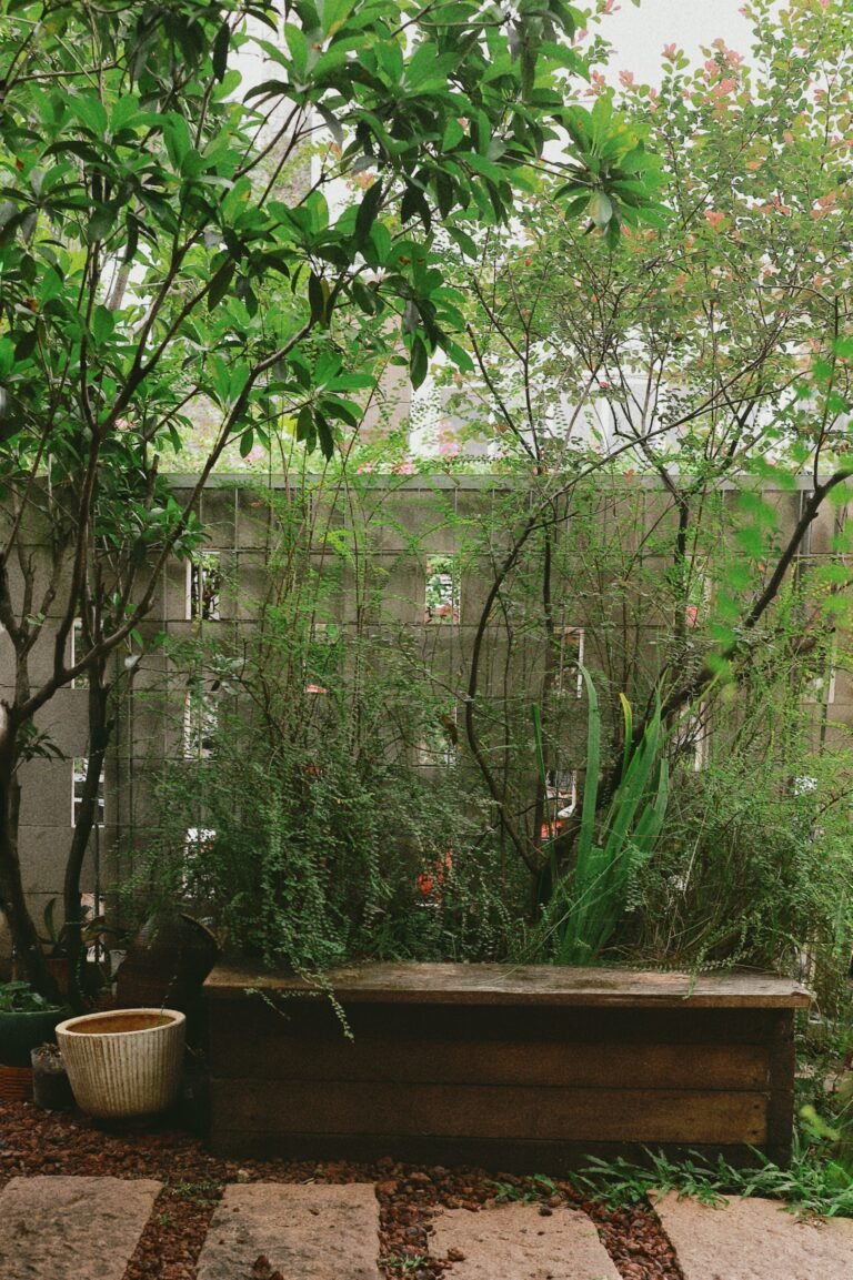 Narrow raised garden planter positioned against a wall, providing space for herbs, salad leaves or strawberries without taking up much patio room.